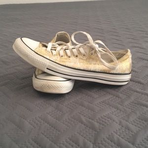 Gold and white converses
